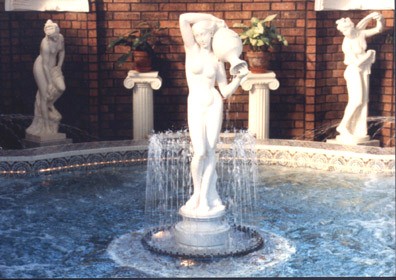 A Statue In The Center Of A Pool